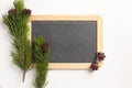 Christmas composition. Spruce branches and blank blackboard, on a white background Royalty Free Stock Photo