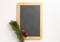 Christmas composition. Spruce branches and blank blackboard, on a white background Royalty Free Stock Photo