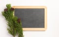 Christmas composition. Spruce branches and blank blackboard, on a white background Royalty Free Stock Photo