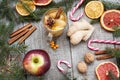 Christmas composition. Spruce branches, candy cane, warming tea with ginger and lemon, dried oranges,