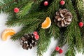 Christmas composition with spruce branches, tangerine and cones