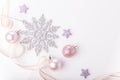 Christmas composition. Spruce branches, xmas tree, xmas pink decor holiday ball with ribbon on white background. Royalty Free Stock Photo