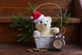 Christmas composition with stuffed toy teddy bear with fir branch and alarm clock on wooden stairs Royalty Free Stock Photo