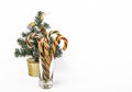 Christmas composition in the style of minimalism a small Christmas tree and a glass of Christmas sweets with a copy of