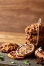 Christmas composition with chocolate biscuits, cinnamon and dried oranges on wooden background, close-up.