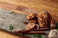 Christmas composition with chocolate biscuits, cinnamon and dried oranges on wooden background, close-up.