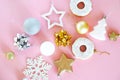 Christmas tree decorations snowflakes, stars, balls, donuts of gold, white and silver on a pink. Royalty Free Stock Photo