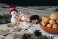 Christmas composition with a toy snowman, paper stars, cones, a