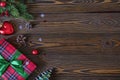 Christmas composition. Christmas tree branches and red gift box on the old wooden table