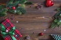 Christmas composition. Christmas tree branches and red gift box on the old wooden table