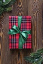 Christmas composition. Christmas tree branches and red gift box on the old wooden table