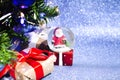 Christmas composition with Christmas tree, gift boxes and Magical Christmas snow globe. Close-up. Copy space. Royalty Free Stock Photo