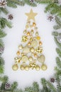 Christmas composition tree made of New year decorations,golden balls,heart,candle, bell and winter things on white