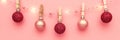 Christmas composition, trendy colors. Banner of shiny christmass garland with hanging by wooden pins pink and red balls