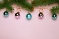 Christmas composition, trendy colors. Banner of shiny christmass garland with pink and skyblue balls over pink background