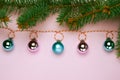 Christmas composition, trendy colors. Banner of shiny christmass garland with pink and skyblue balls over pink background