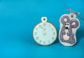 Wo handmade gingerbread in the form of a clock and a funny gray rat with a silver bow on a light blue background. Christmas, winte Royalty Free Stock Photo