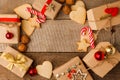 Christmas composition of various gift boxes in craft paper decorated red gold ribbons and holiday sweetness gingerbread cookies Royalty Free Stock Photo