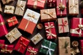 Christmas composition of various gift boxes wrapped in craft and decorated with satin red ribbons.