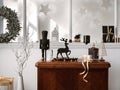 Christmas composition on the vintage shelf in the living room interior with beautiful dark decoration, big window, christmas tree Royalty Free Stock Photo