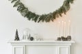 Christmas composition on the white chimney at the living room interior with beautiful decoration. Royalty Free Stock Photo