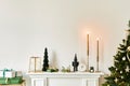 Christmas composition on the white chimney at the living room interior with beautiful decoration. Royalty Free Stock Photo