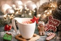 Christmas composition with white cup with hot drink with marshmallows on cozy background close up Royalty Free Stock Photo