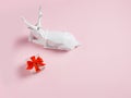 Christmas composition with white reindeer and red gift box on pastel pink background. Creative Xmas or New year concept. Royalty Free Stock Photo