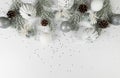 Christmas composition, white and silver decorations, fir tree branches, pinecones, silver stars confetti on white background.