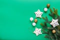 Christmas composition. White stars in a golden dot, green and gold Christmas balls and Christmas tree branch Royalty Free Stock Photo