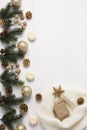 Christmas composition on white wooden background with fir branches, balls, cones and candles