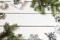 Christmas composition on a white wooden background. white gift boxes, with a silver ribbon with fir branches, toys. Copy space for Royalty Free Stock Photo