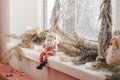 Christmas composition on the windowsill. Toy Santa Claus sits on the windowsill Royalty Free Stock Photo