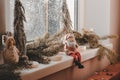 Christmas composition on the windowsill. Toy Santa Claus sits on the windowsill Royalty Free Stock Photo