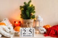 Christmas composition with wood calendar in Scandinavian hygge style. Beautiful cozy home decor composition with candles, lantern