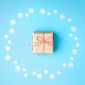 Christmas composition. Wreath made of snowflakes with gift in the center on pastel blue background. Christmas, winter, new year Royalty Free Stock Photo