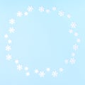 Christmas composition. Wreath made of snowflakes on pastel blue background. Flat lay, top view, copy space Royalty Free Stock Photo