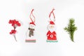 Christmas composition with xmas tree branch, red berries and xmas toys santa claus and snowman on white background Royalty Free Stock Photo