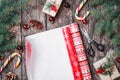 Christmas composition with xmas wrapping, Fir branches, gifts, pine cones, red decorations on wooden background Royalty Free Stock Photo