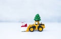 Christmas concept background, Yellow truck carry Christmas tree and moving snow man toy over blurred background Royalty Free Stock Photo