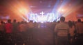 Christmas concept: Blurred Christian Congregation Worship God together in Church hall in front of music stage and light effected Royalty Free Stock Photo