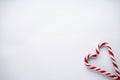 Christmas concept. Christmas candy in the corner in the form of a heart on a white background. Place for text, flat lay
