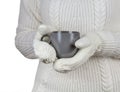 Christmas concept. Coffee cup in female hands dressed in mittens