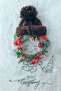 Christmas concept. Cute baby made of wreath of evergreen spruce, knitted on a white background. Minimal winter idea Royalty Free Stock Photo