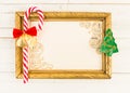 Christmas concept with empty picture frame and cane candy
