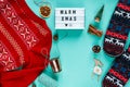 Christmas Background Christmas concept flat lay. Warm, cozy winter knitted clothing, light box and Christmas decorations frame