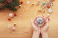 Christmas concept. Human hand hold a glass christmas bauble with festive lights Royalty Free Stock Photo