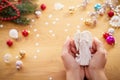 Christmas concept. Human hands hold a ceramic christmas decoration in a shape of angel Royalty Free Stock Photo