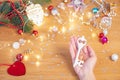 Christmas concept. Human hands hold a ceramic christmas decoration in a shape of key Royalty Free Stock Photo