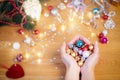 Christmas concept. Human hands hold a glass christmas baubles Royalty Free Stock Photo